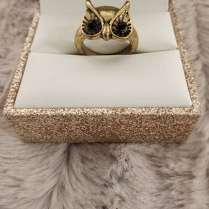 One owl ring and three faux diamond rings